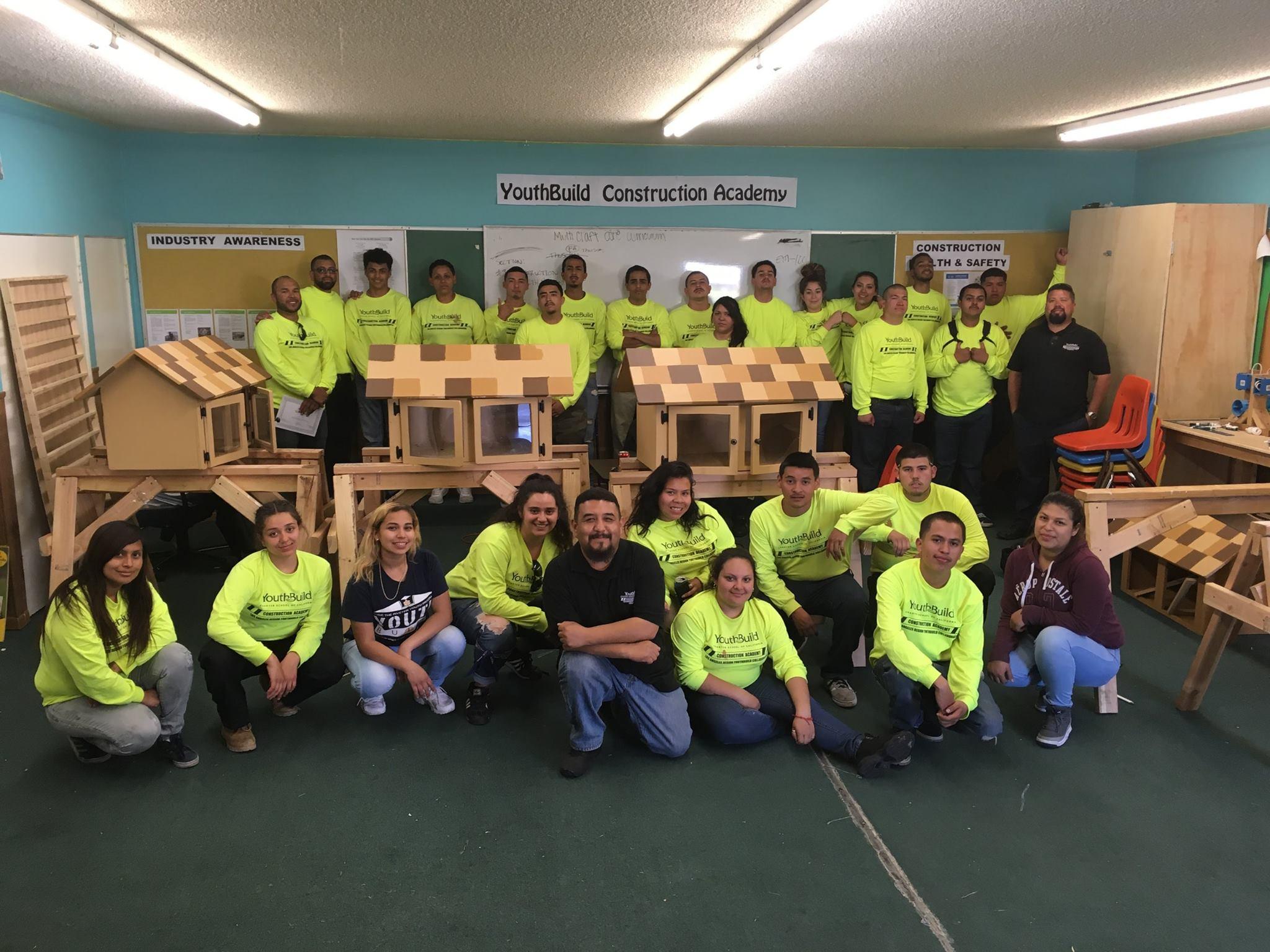 Construction Academies students pose with their little free libraries