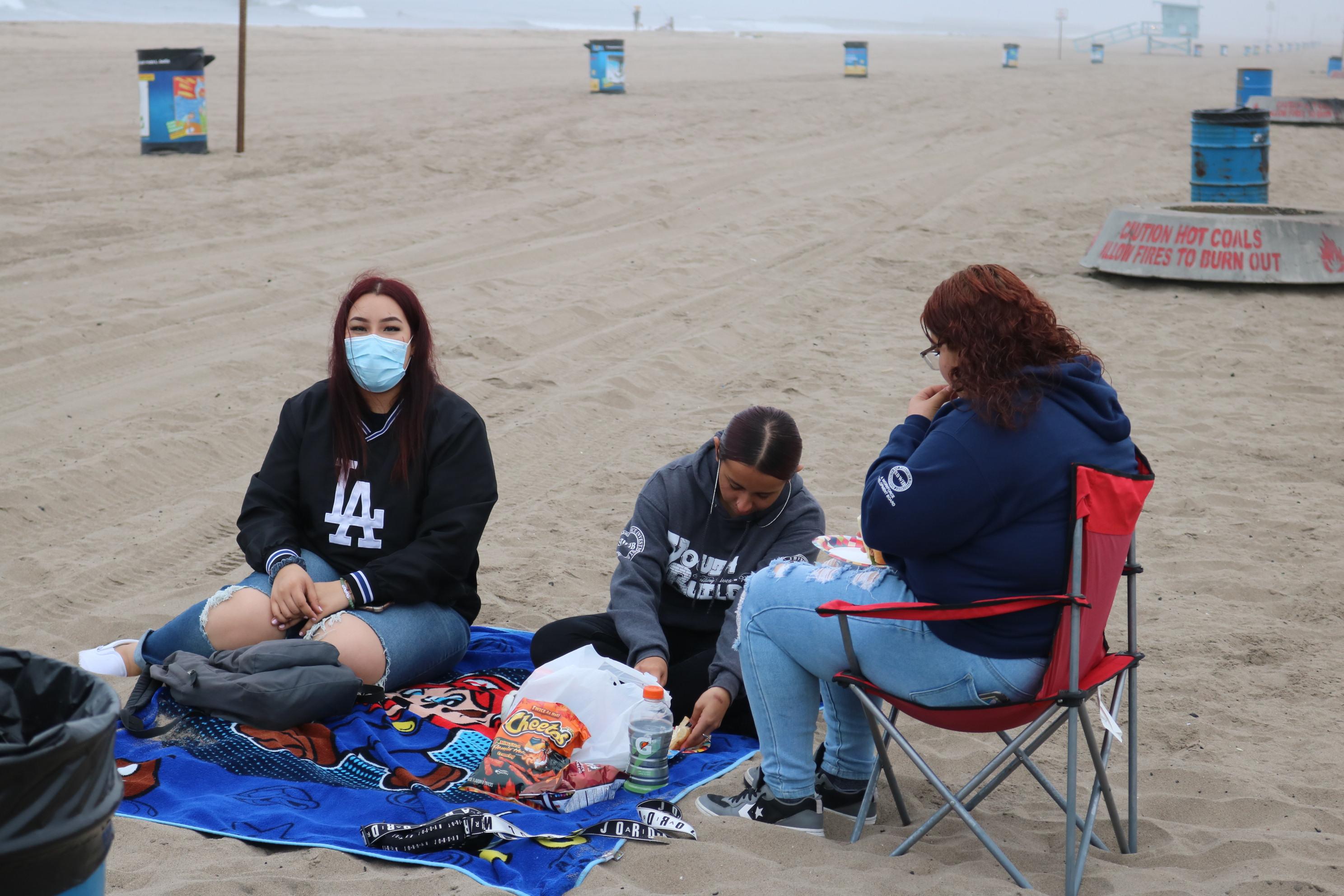 students eat lunch on the beach