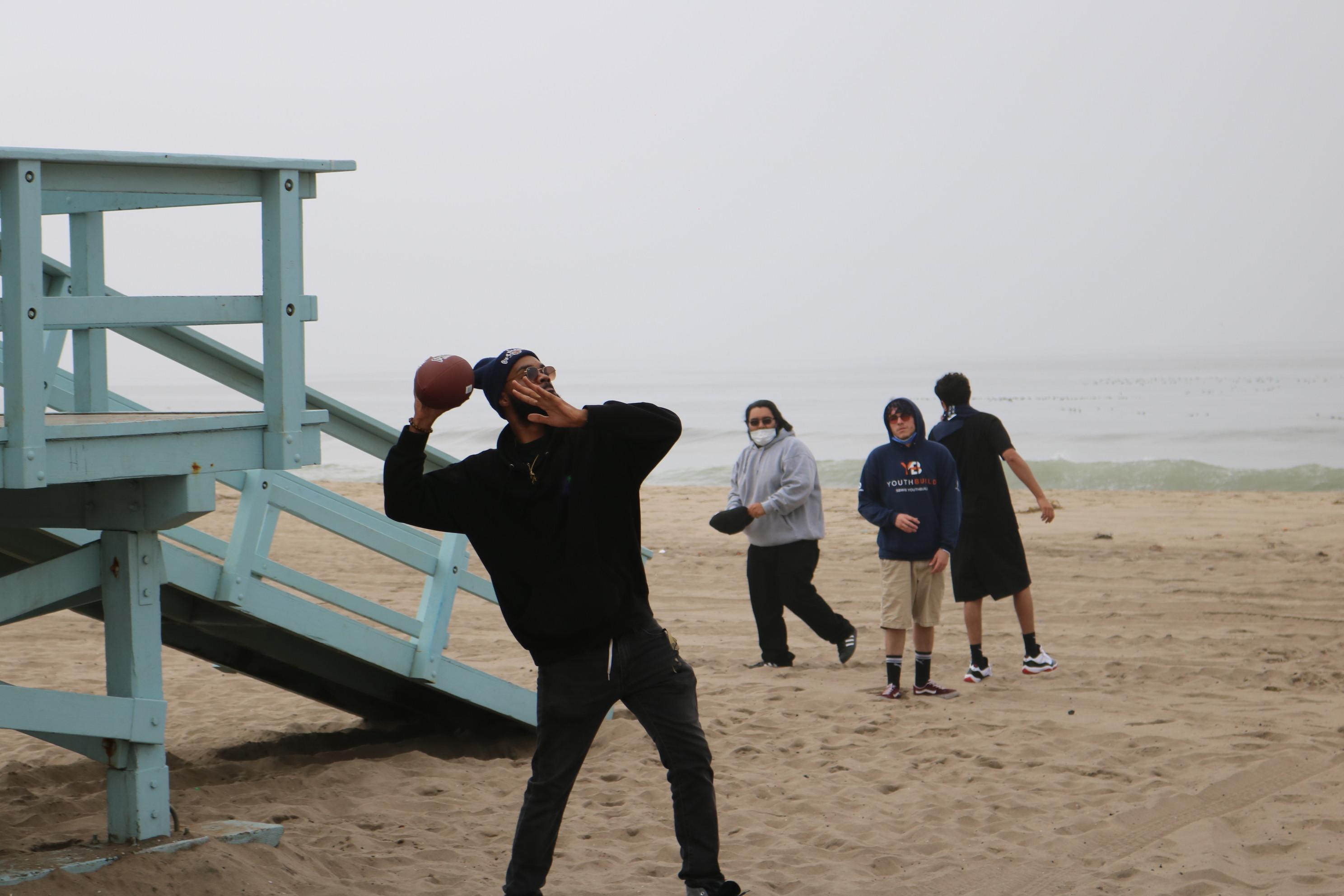 A Lennox student gets ready to throw a football on the beach