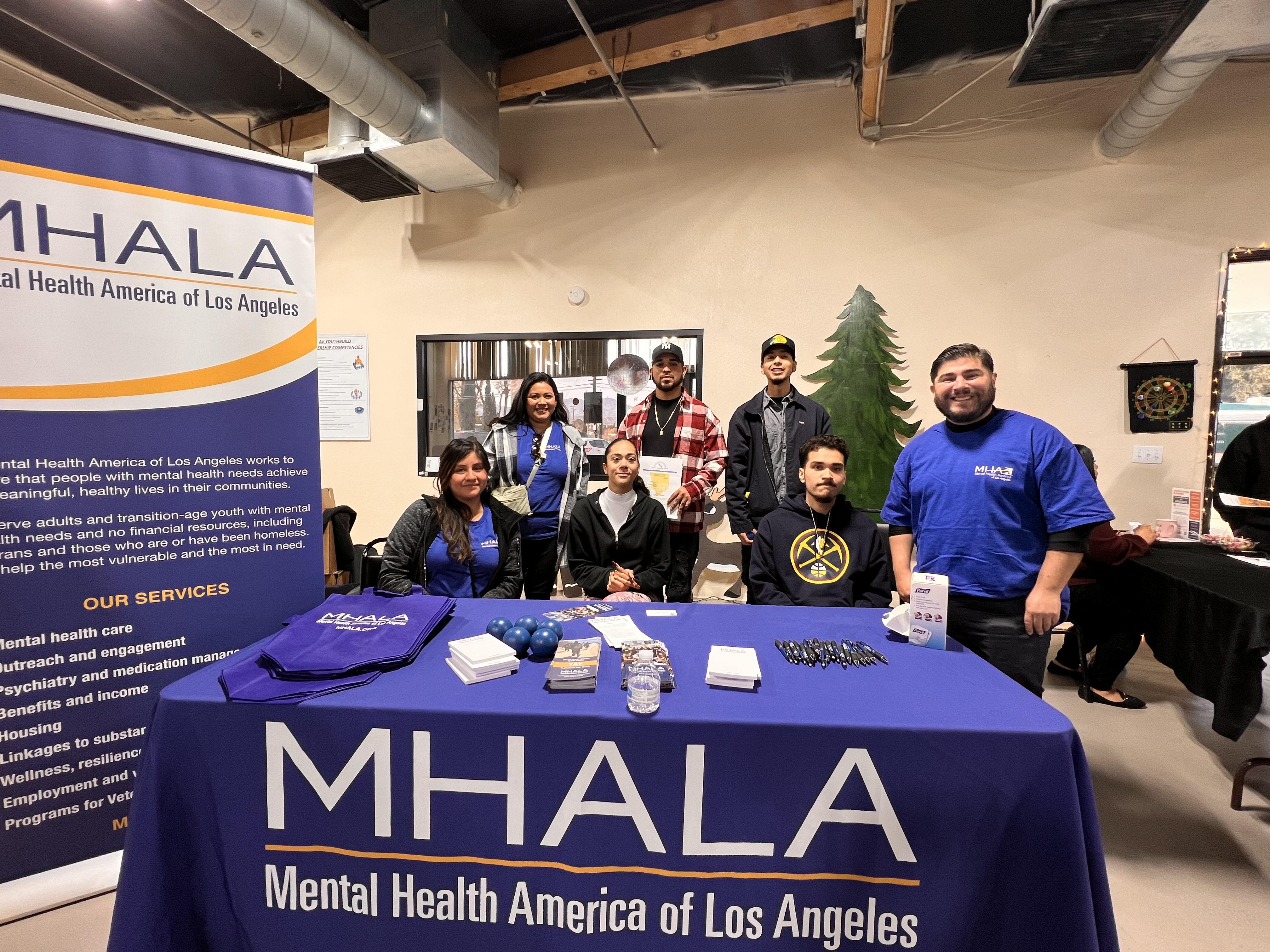 A table of people from the non-profit MHALA 