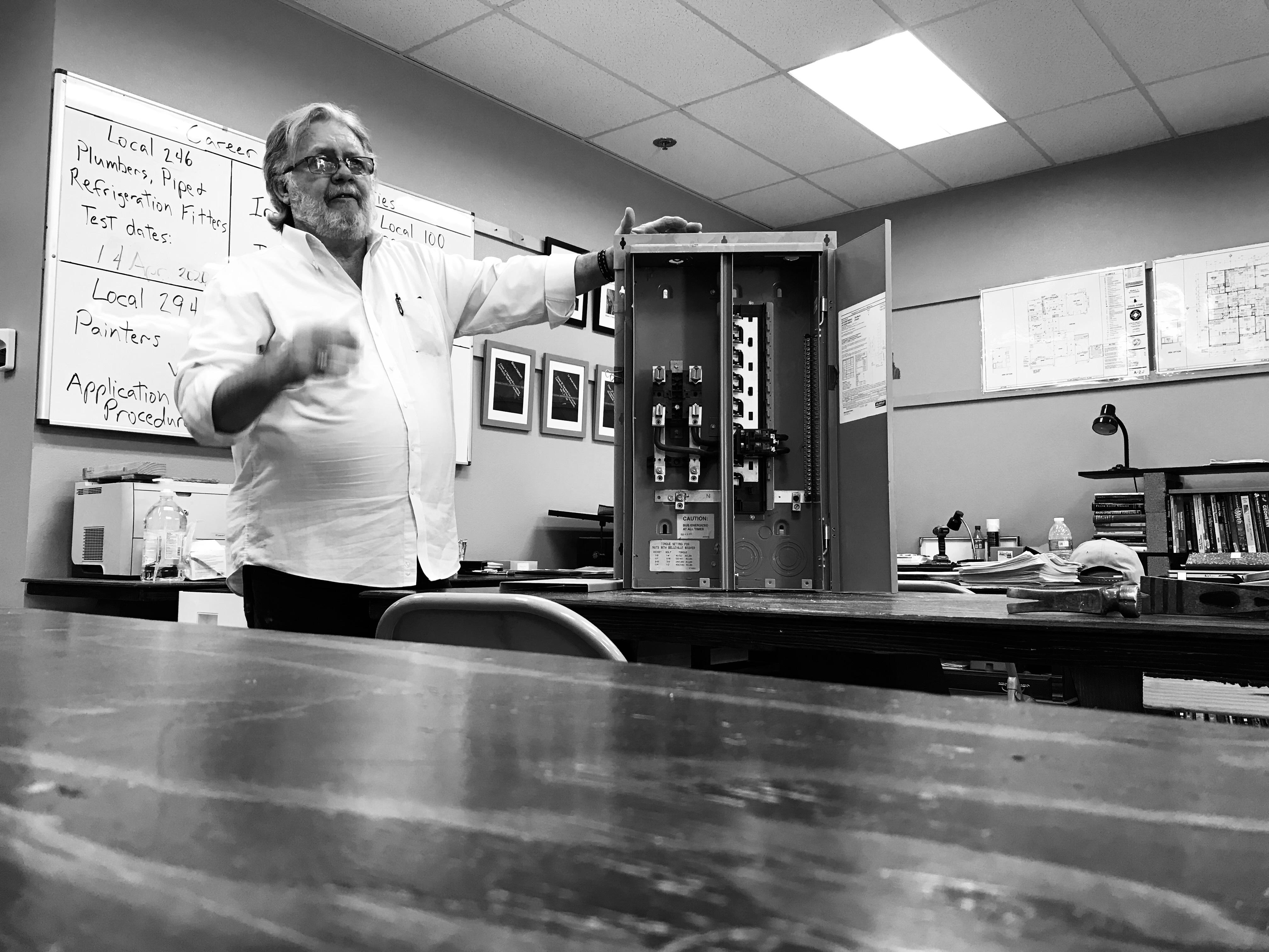 Black and white photo of Mr. Nelson teaching construction class 