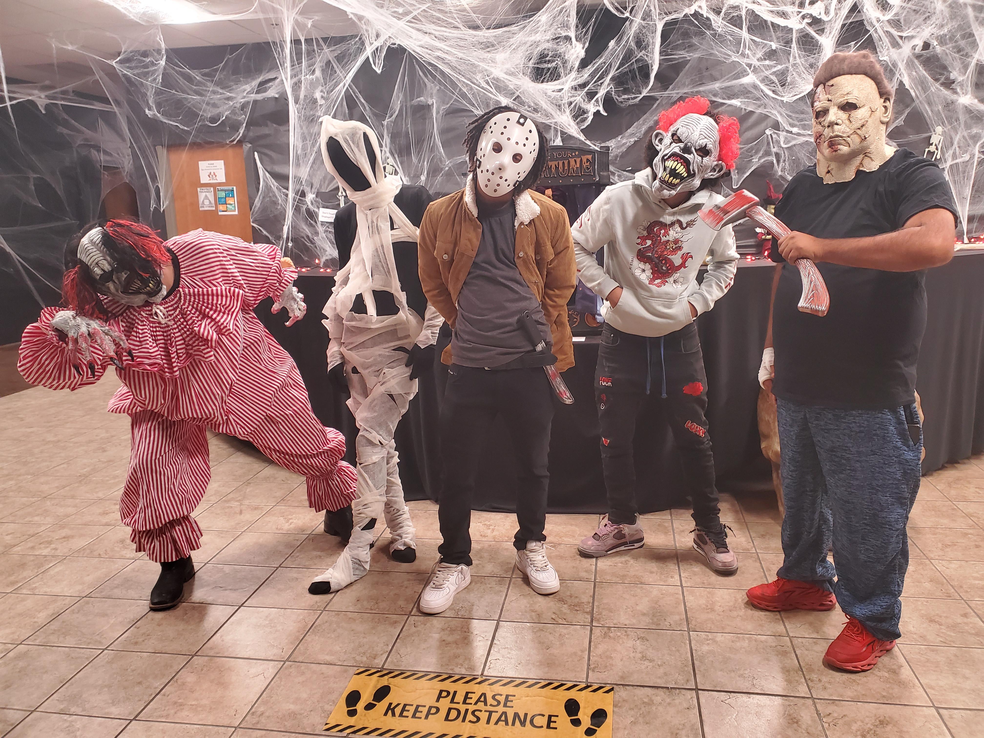 students pose in scary Halloween costumes