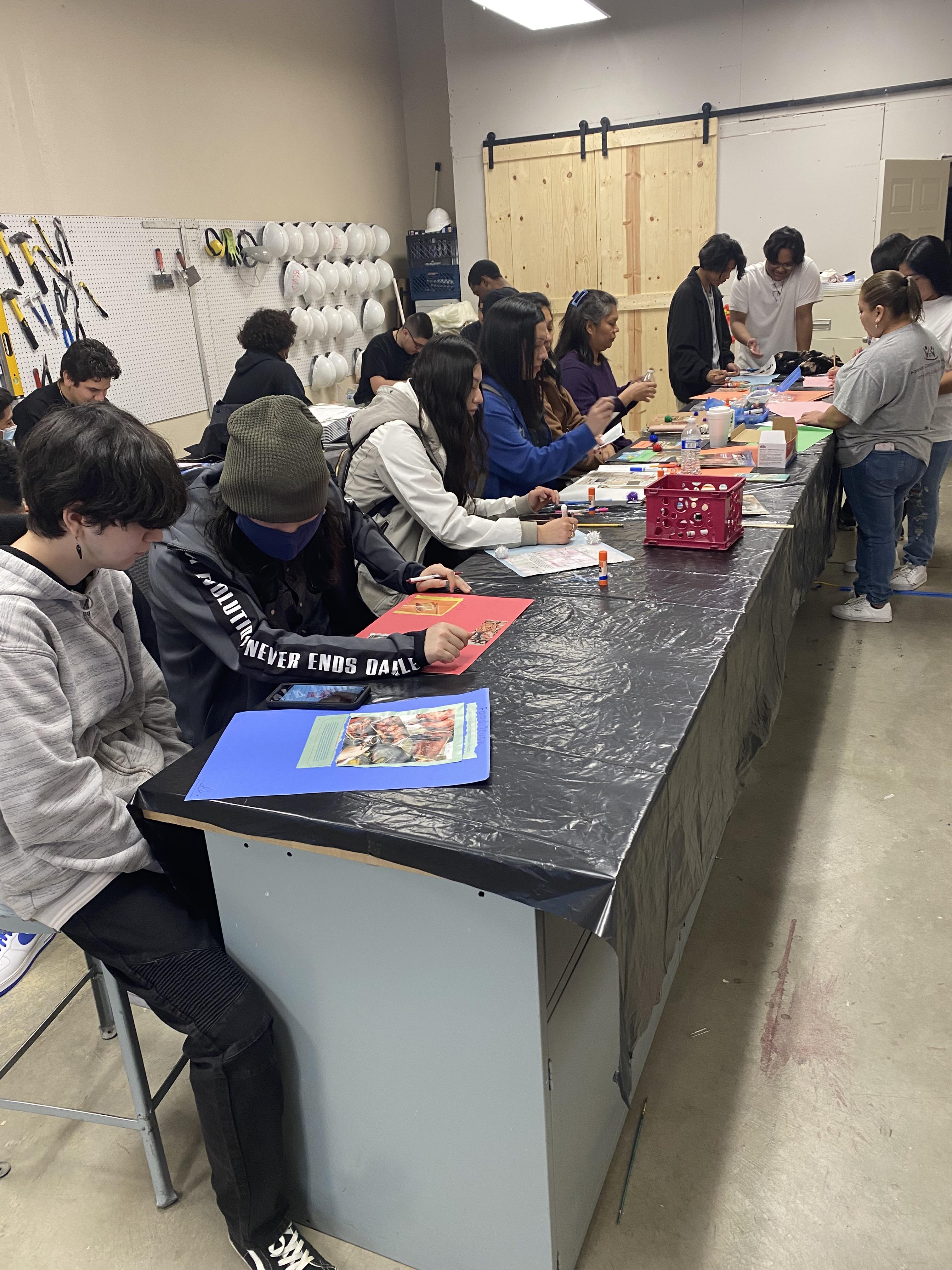 Students and family members work on art